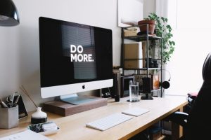 Computer on desk with Do More on the monitor