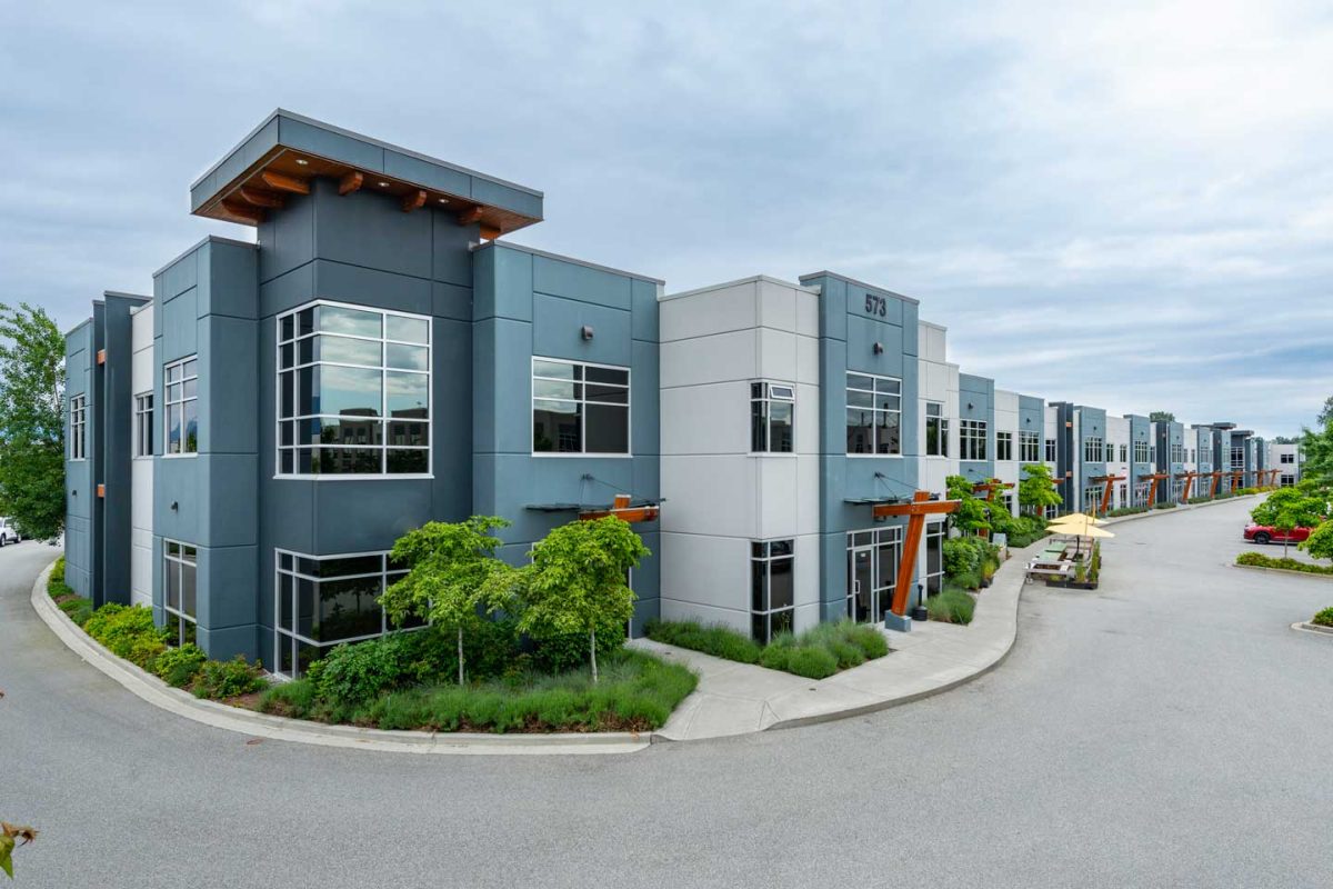 large commercial building with parking lot in industrial area