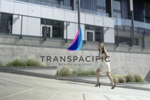 Transpacific Realty Advisors logo woman walking in background